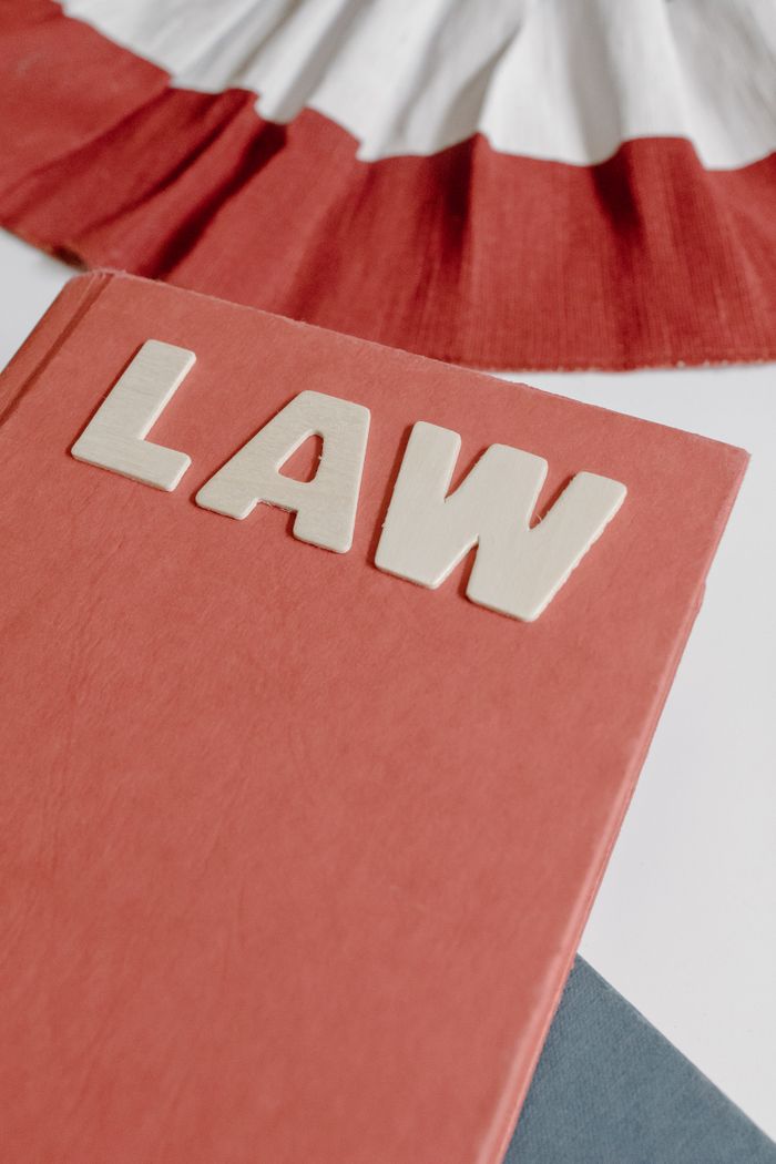 About Close-up of a red hardcover law book with bold lettering on a light surface.
